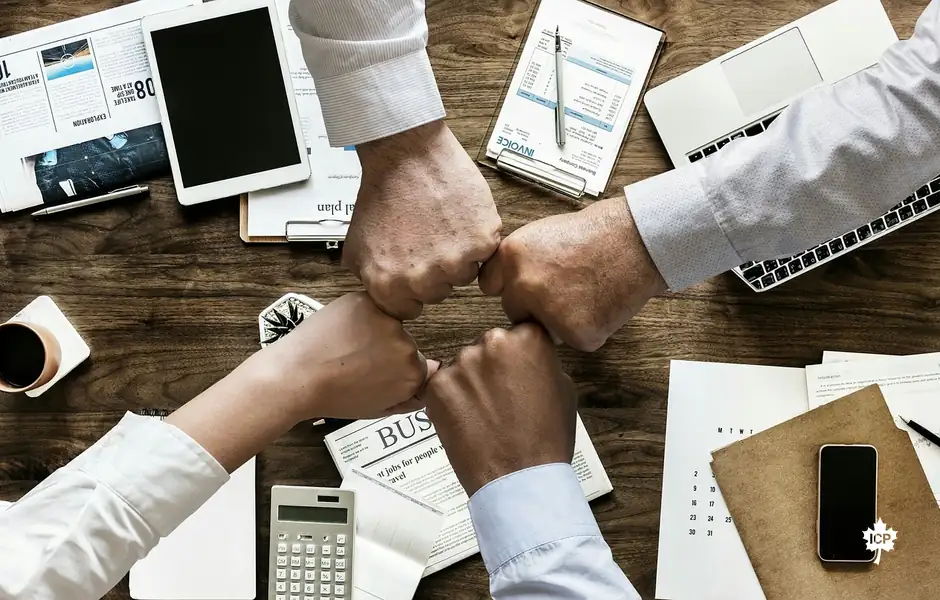 Hands joined over a work desk