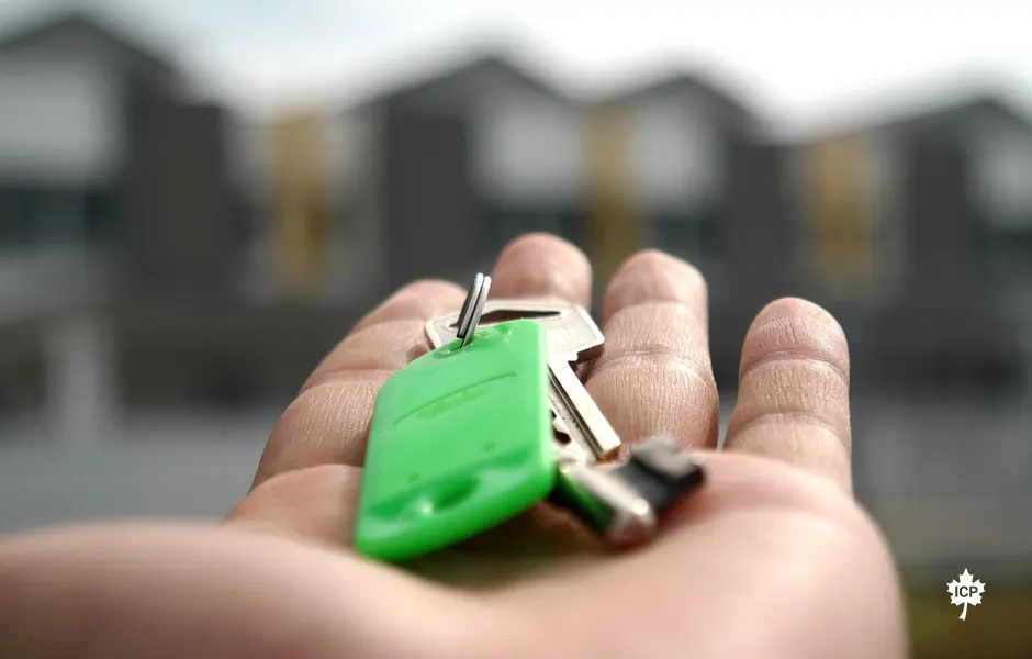 House keys in front of homes